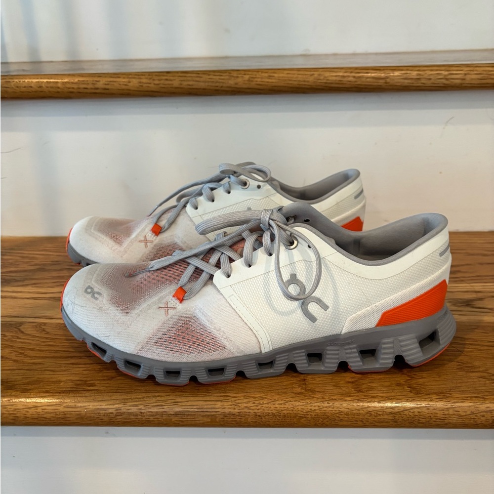 On Running White and Gray Shoes with Orange Details